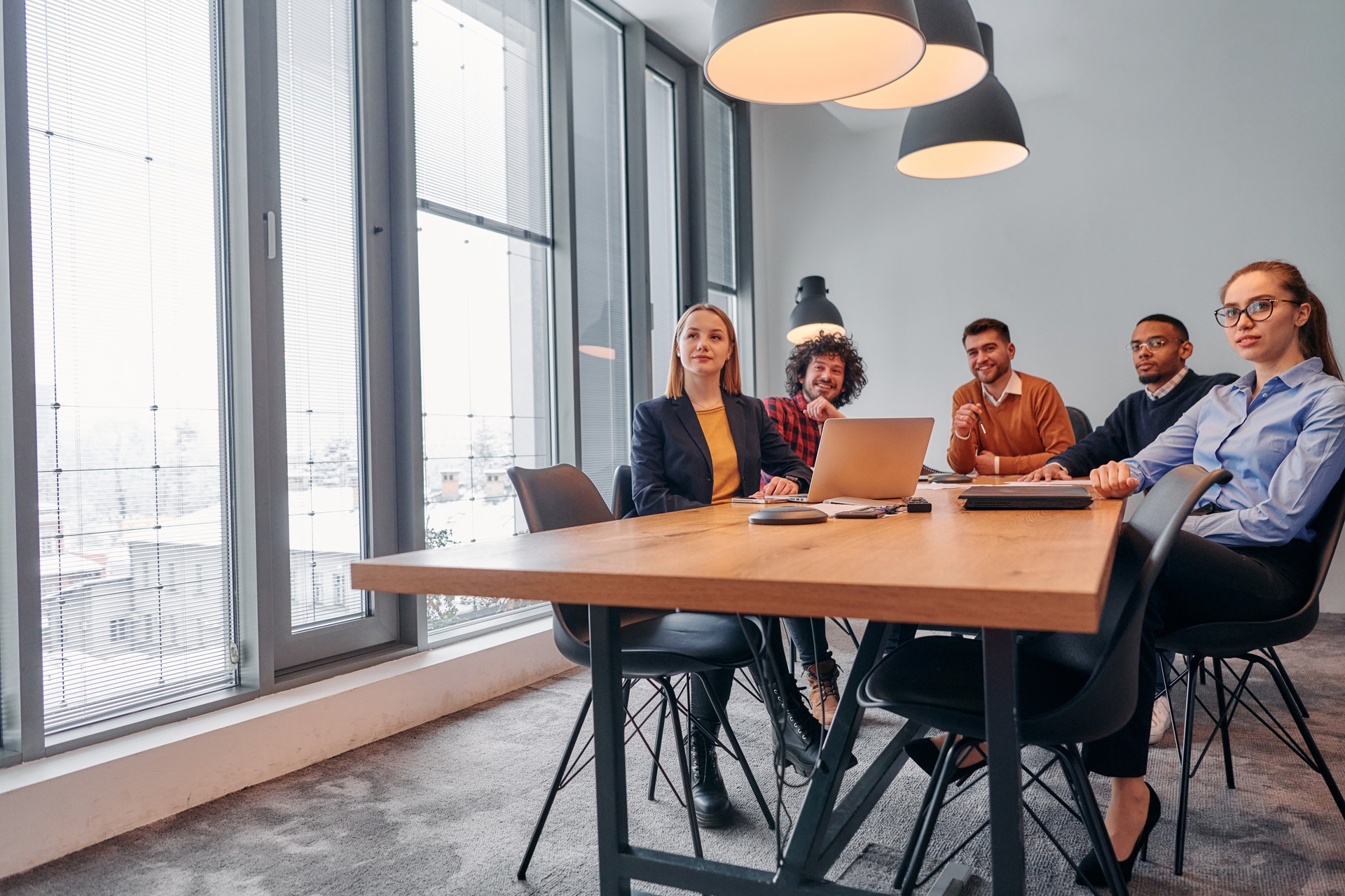 Dynamic Entrepreneurial Team Strategizing Projects in Modern Office Meeting.